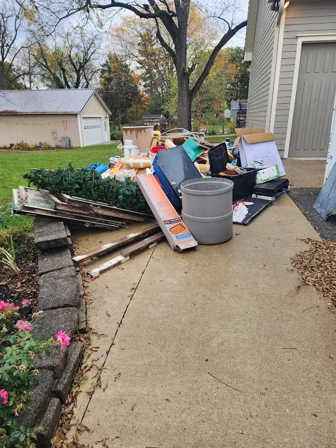 Dumpster being loaded with debris for Roofing Dumpster Rental in Longbranch